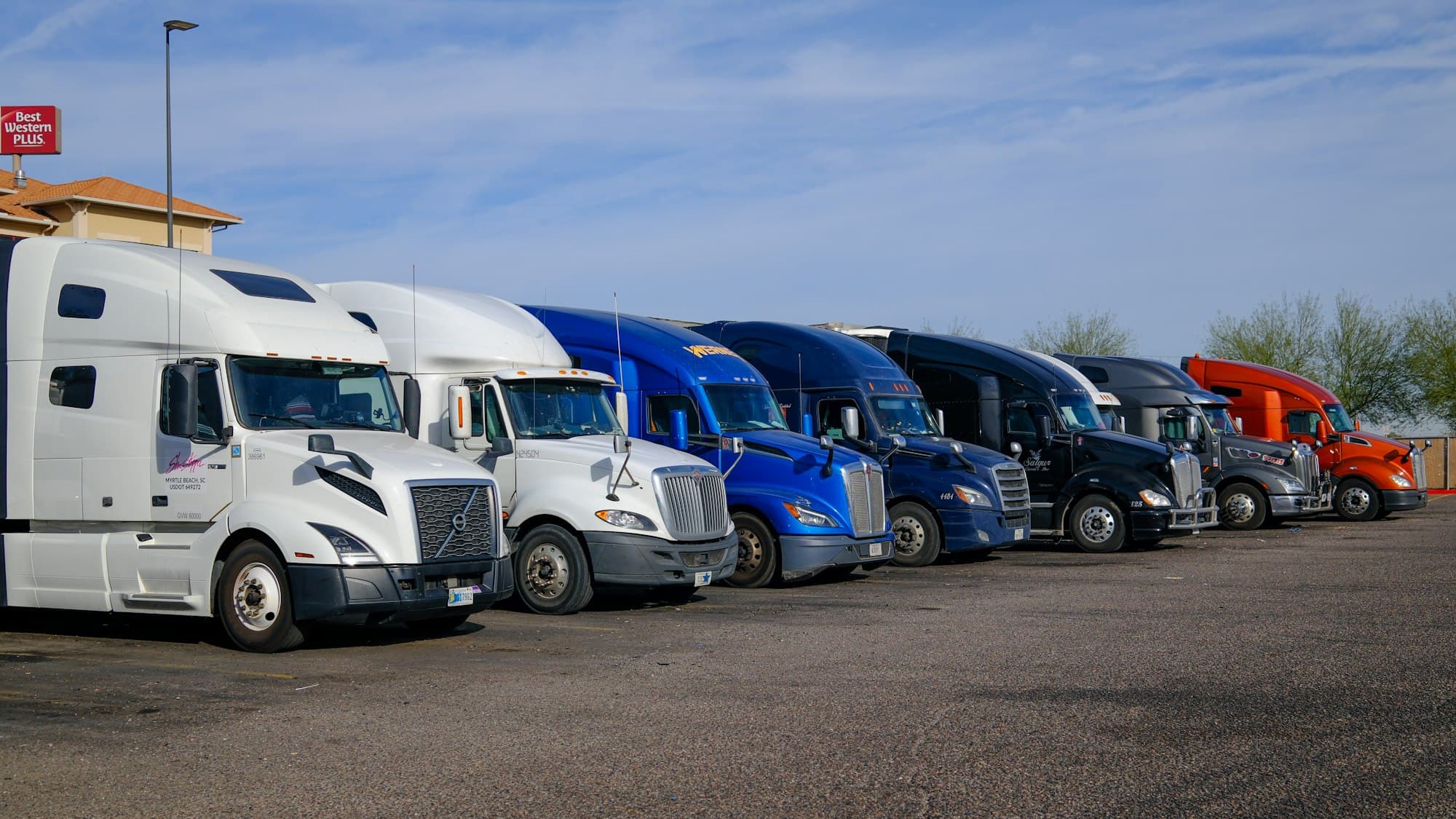 A row of tractors from several fleets parked side by side